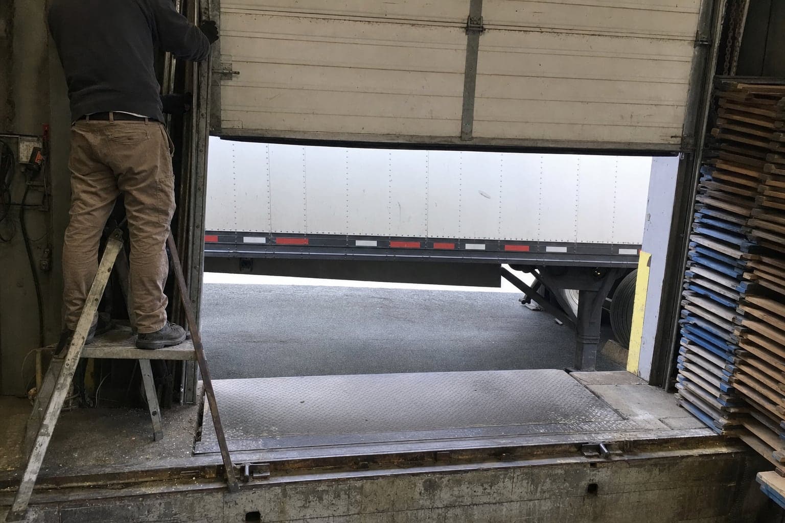 Repairing a loading dock door from inside the dock