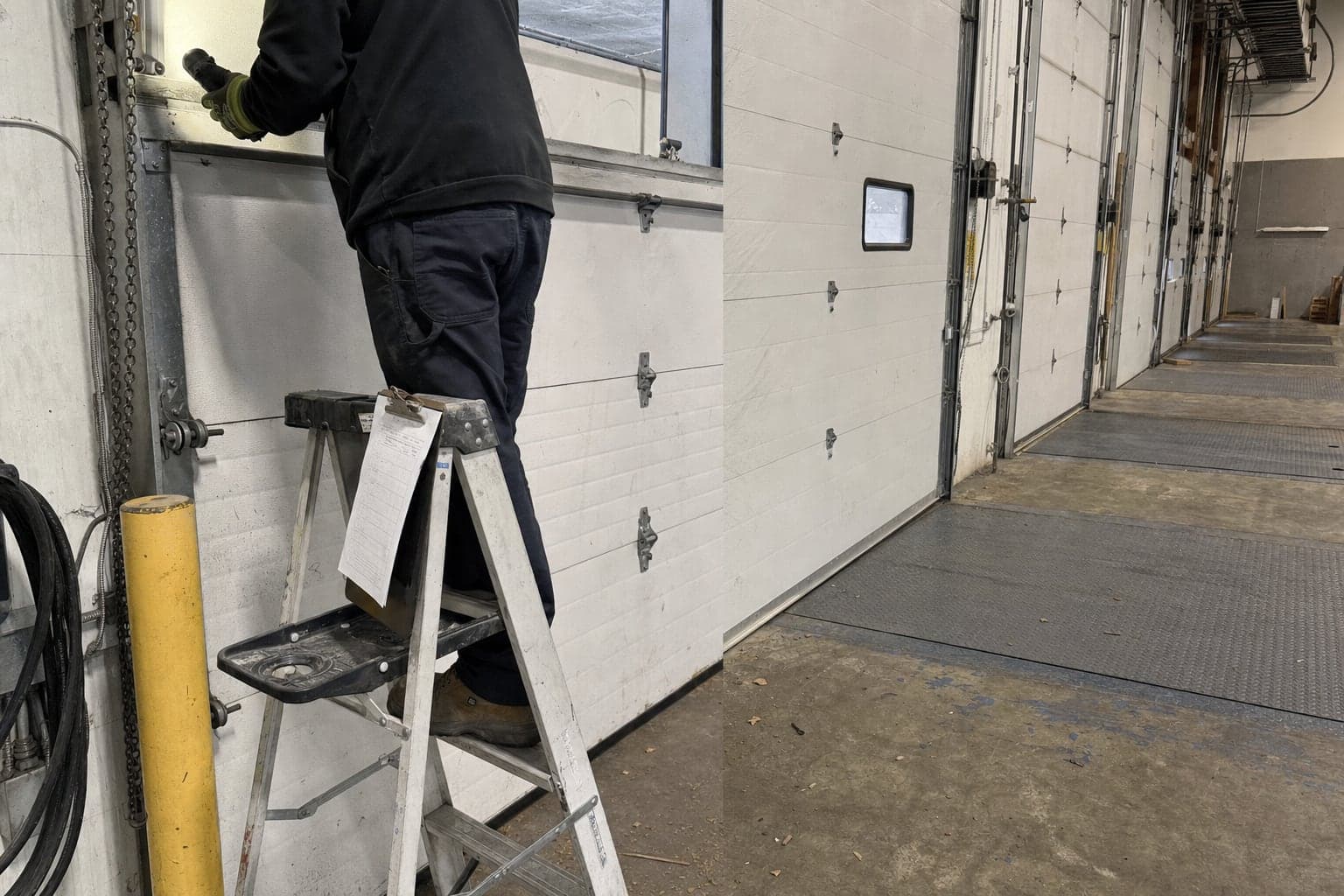 Service check on a row of warehouse dock doors
